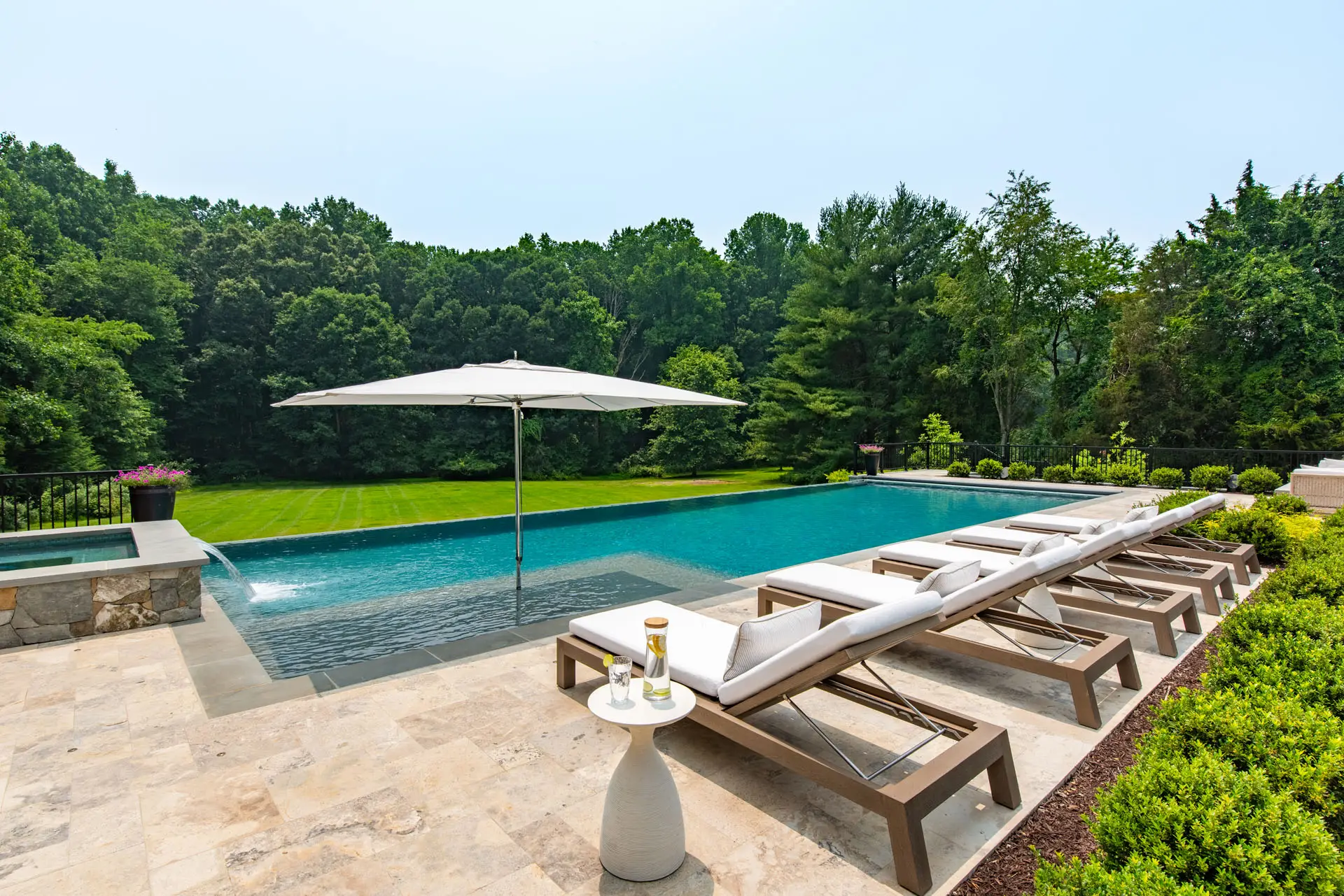 view from pool of trees and back yard